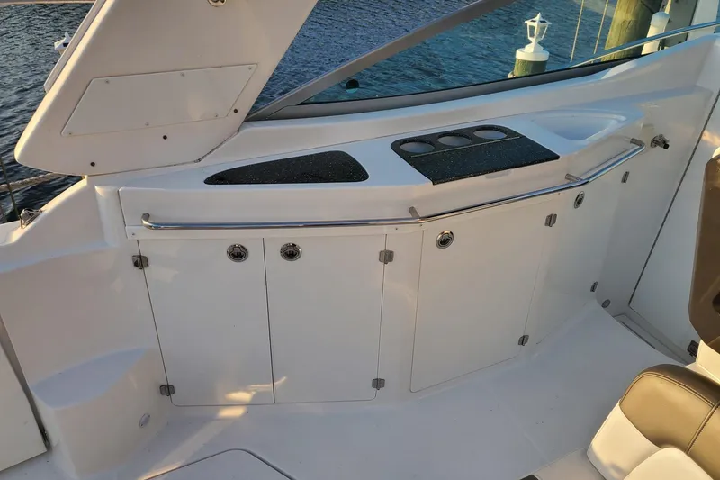 Slide: The Image of 2015 Monterey 315 Sport Yacht interior with sleek cabinetry and cup holders. - 33