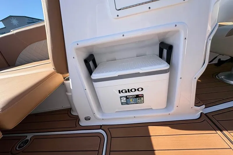 Slide: The Image of Built-in Igloo cooler on 2026 NauticStar 223 DC Deck boat, featuring stylish seating and flooring. - 10