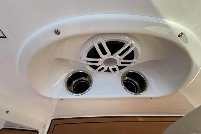 Slide: The Image of Speaker and cup holders on 2026 NauticStar 223 DC Deck boat. - 11