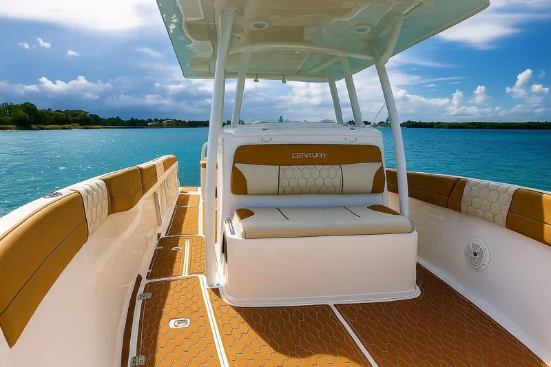 Slide: The Image of 2019 Century 3200 Center Console boat on calm blue water, featuring tan and white seating. - 24