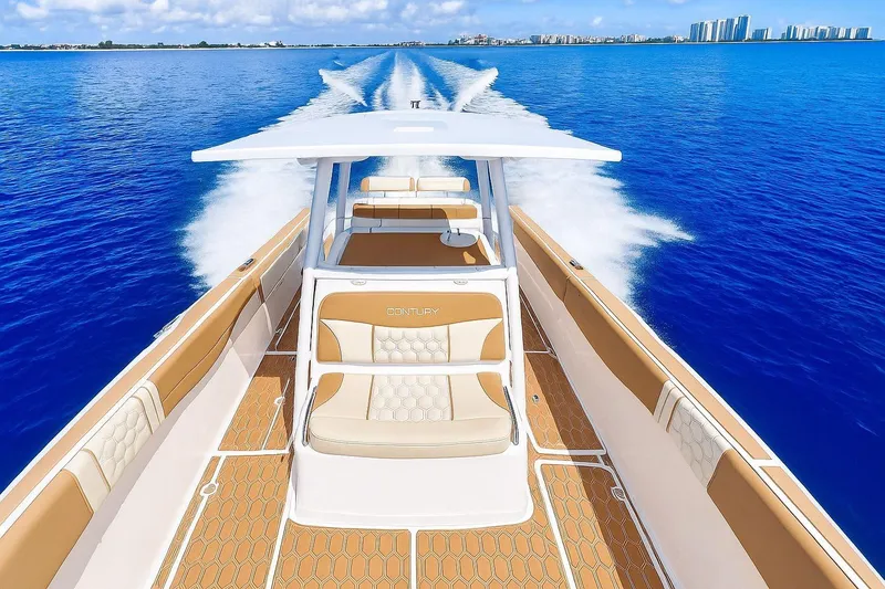 Slide: The Image of 2019 Century 3200 Center Console boat cruising on clear blue water. - 25