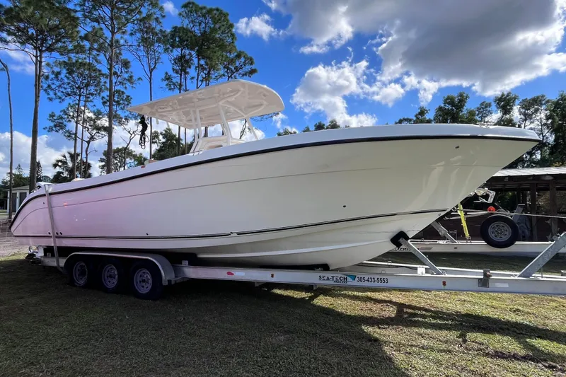 Slide: The Image of 2019 Century 3200 Center Console boat on trailer, surrounded by trees and blue sky. - 26
