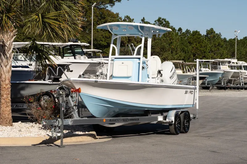 The Image of 2026 Sea Pro 230 Bay boat on trailer, parked outdoors near palm tree. - 1
