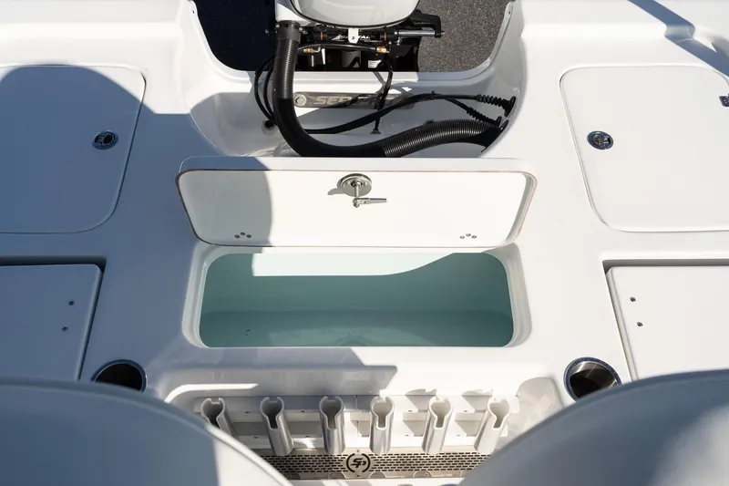 Slide: The Image of 2026 Sea Pro 230 Bay boat interior with storage compartments and rod holders. - 10