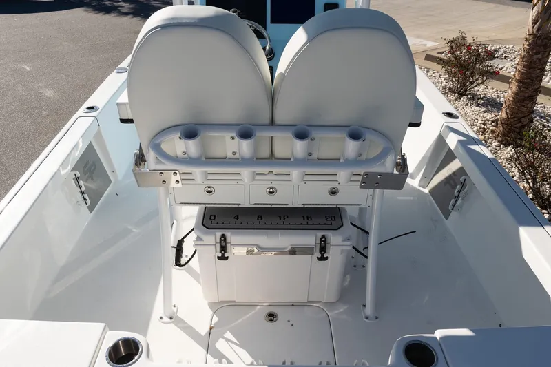 Slide: The Image of 2026 Sea Pro 230 Bay boat interior with seating, rod holders, and storage. - 11