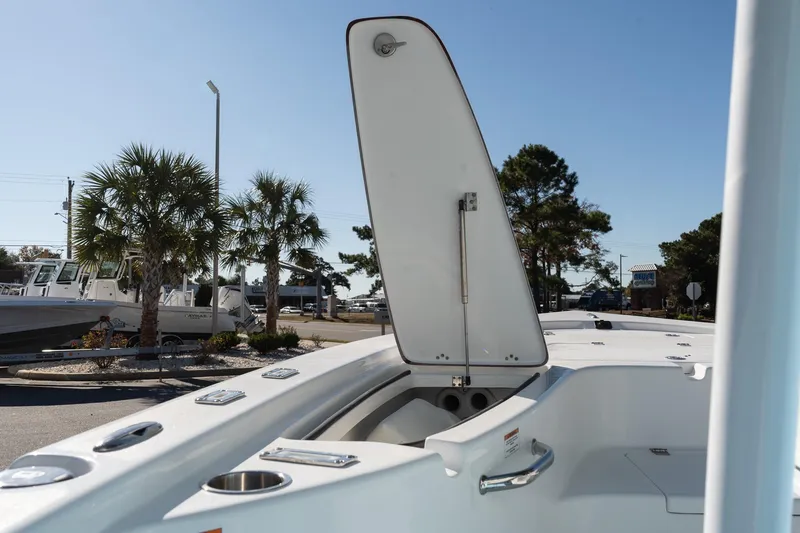 Slide: The Image of 2026 Sea Pro 230 Bay boat with open storage compartment, palm trees in background. - 16