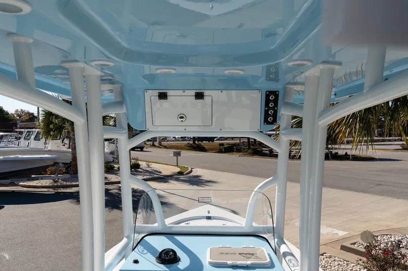 Slide: The Image of 2026 Sea Pro 230 Bay boat interior with blue T-top and console view. - 20