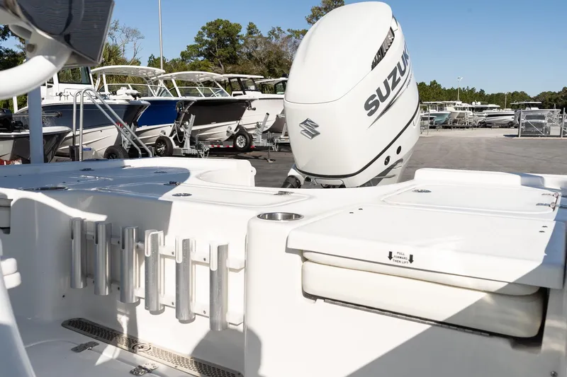 Slide: The Image of 2026 Sea Pro 230 Bay boat with Suzuki outboard motor, docked among other boats. - 7