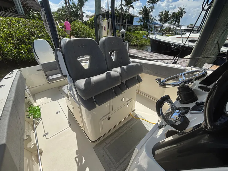 Slide: The Image of 2023 Stingray 273 CC boat interior with dual seats and steering console. - 15
