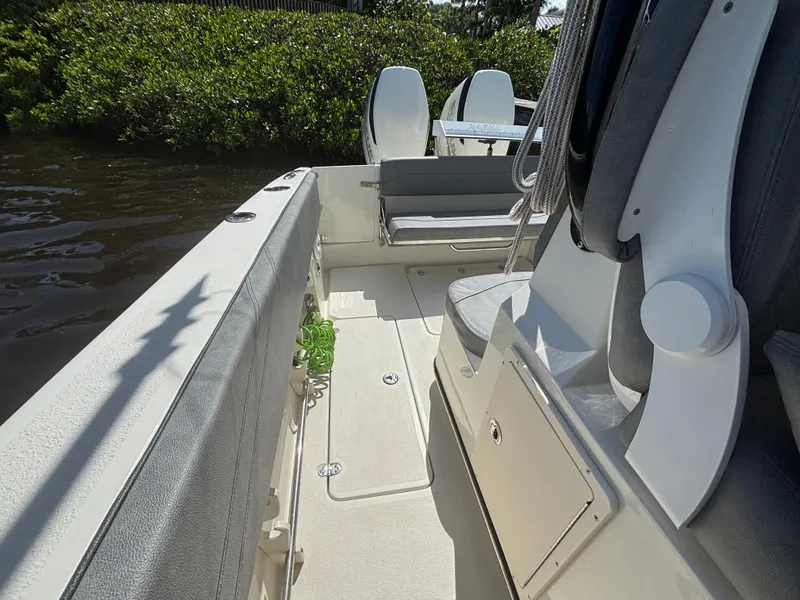Slide: The Image of 2023 Stingray 273 CC boat interior with seating and storage compartments. - 16