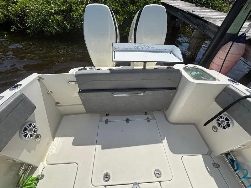 Slide: The Image of 2023 Stingray 273 CC boat interior with seating, speakers, and fishing equipment. - 20