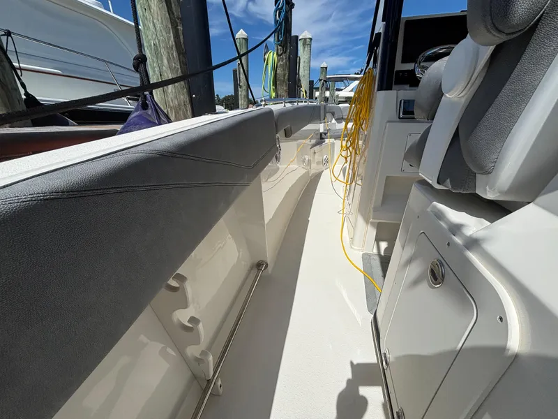 Slide: The Image of 2023 Stingray 273 CC boat interior with seating and storage compartments. - 27
