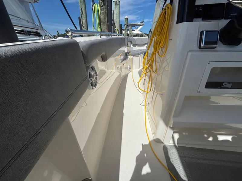 Slide: The Image of 2023 Stingray 273 CC boat interior with seating, speaker, and yellow rope. - 28