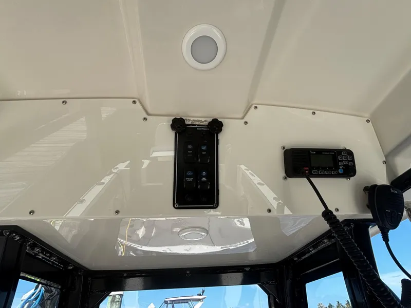 Slide: The Image of 2023 Stingray 273 CC boat interior with control panel and communication device. - 31