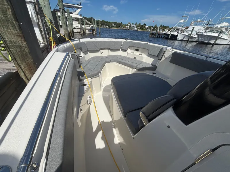 Slide: The Image of 2023 Stingray 273 CC boat interior with seating, docked at marina. - 35