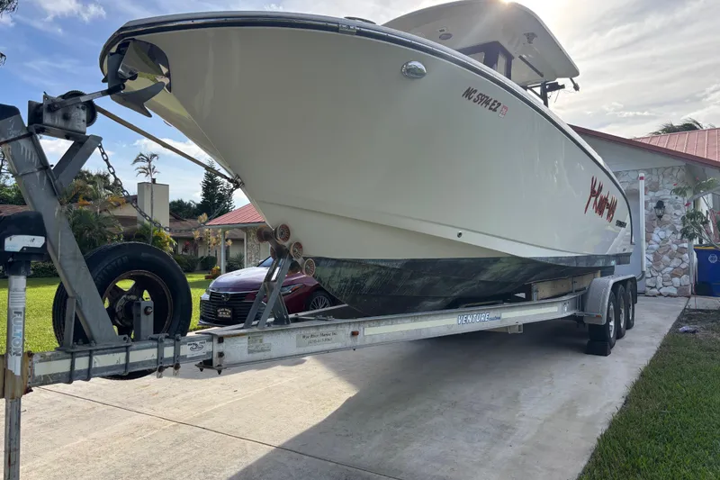 Slide: The Image of 2023 Stingray 273 CC boat on trailer in driveway, sunny day. - 37