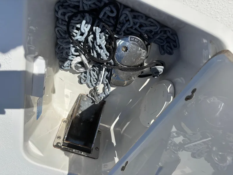 Slide: The Image of Anchor compartment of 2023 Stingray 273 CC boat with chain and winch. - 6