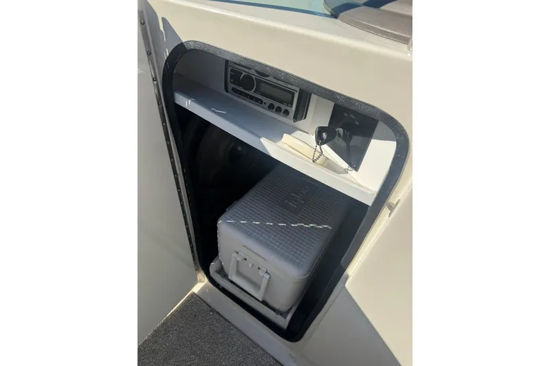 Slide: The Image of Storage compartment in a 2008 Sea Ray 260 Sundeck with radio and cooler. - 10