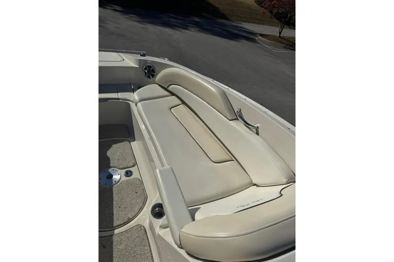 Slide: The Image of 2008 Sea Ray 260 Sundeck boat interior with beige seating and carpeted floor. - 11