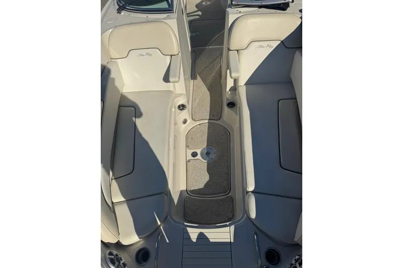 Slide: The Image of 2008 Sea Ray 260 Sundeck interior with beige seating and carpeted floor. - 13