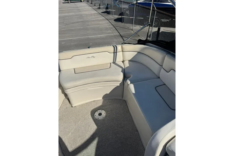 Slide: The Image of 2008 Sea Ray 260 Sundeck interior with beige seating and carpeted floor. - 5