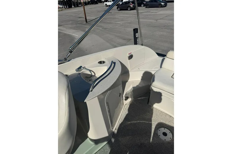 Slide: The Image of 2008 Sea Ray 260 Sundeck interior with seating and sink in a parking lot. - 6