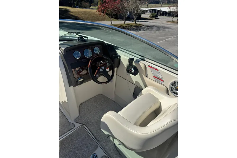 Slide: The Image of 2008 Sea Ray 260 Sundeck boat cockpit with steering wheel and control panel. - 7