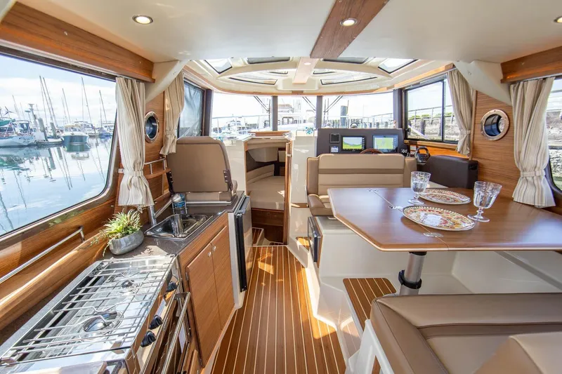 Slide: The Image of Luxurious interior of 2026 Ranger Tugs R-29CB with elegant wood finishes and modern amenities. - 13