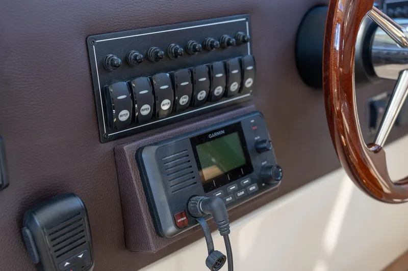 Slide: The Image of 2026 Ranger Tugs R-29CB dashboard with controls and Garmin device. - 20