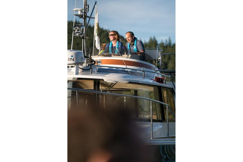 Slide: The Image of Couple enjoying a scenic ride on a 2026 Ranger Tugs R-29CB boat. - 28