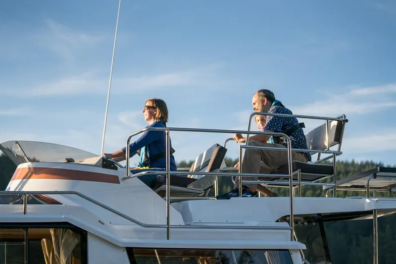 Slide: The Image of 2026 Ranger Tugs R-29CB boat with people enjoying a sunny day on the water. - 31