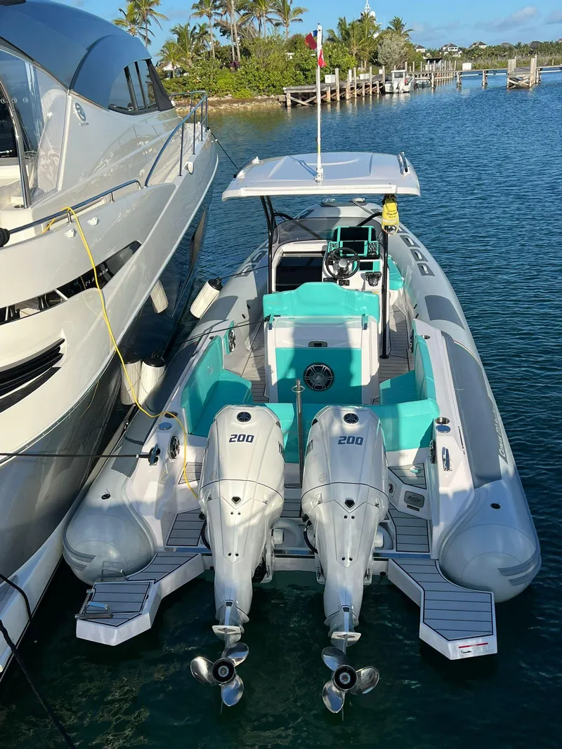 Slide: The Image of 2025 Ranieri CAYMAN 27.0 SPORT TOURING boat docked beside a yacht. - 28