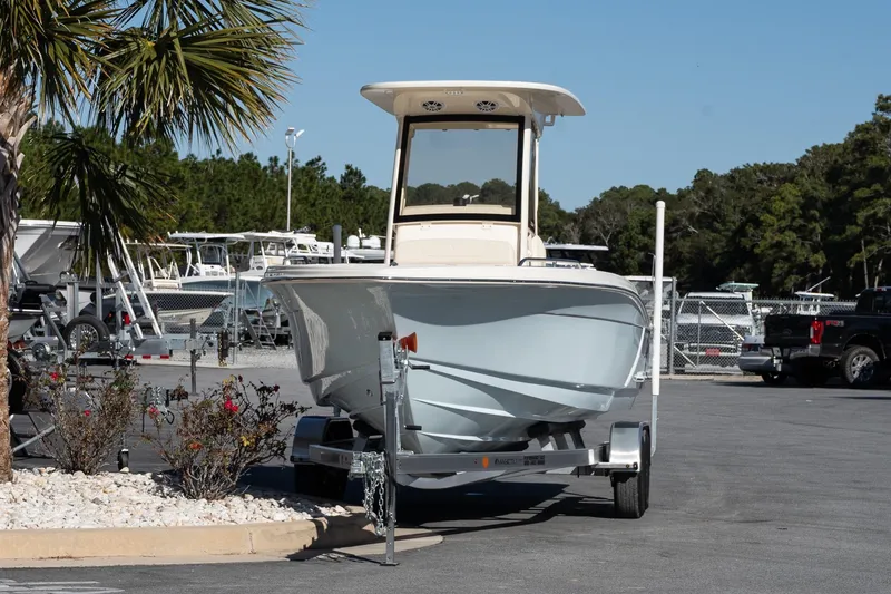 Slide: The Image of 2026 Scout 220 XSF boat on trailer in sunny outdoor setting. - 3