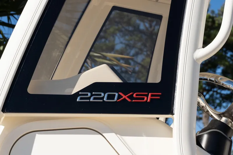 Slide: The Image of 2026 Scout 220 XSF boat window with logo in sunlight. - 7