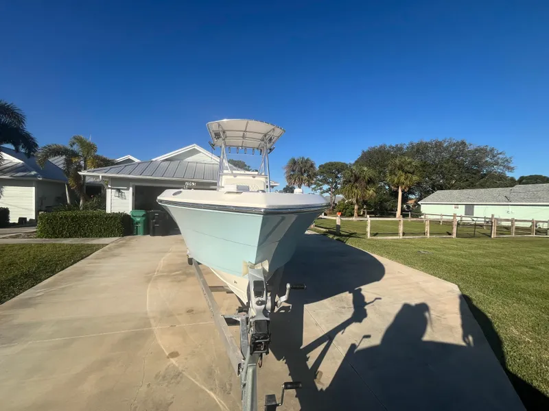 Slide: The Image of 2019 Cobia 237 Center Console boat on trailer in residential driveway. - 13