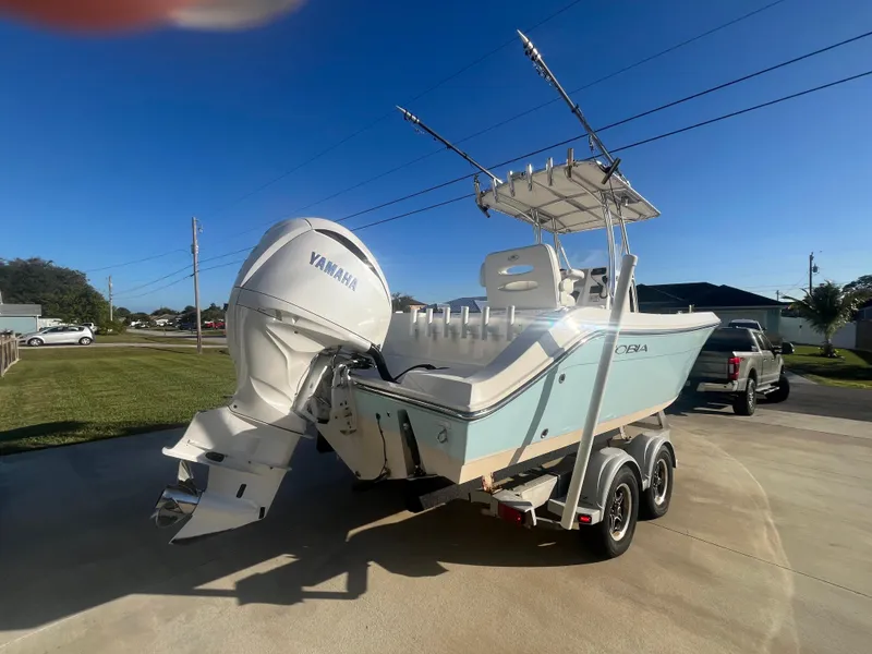 Slide: The Image of 2019 Cobia 237 Center Console boat with Yamaha engine on trailer, parked outdoors. - 18