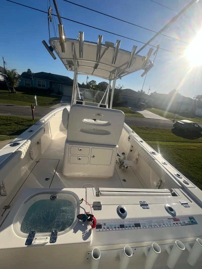 Slide: The Image of 2019 Cobia 237 Center Console boat with T-top and fishing rod holders. - 21