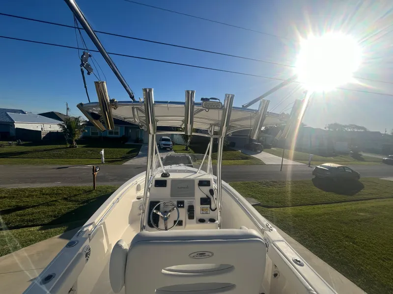 Slide: The Image of 2019 Cobia 237 Center Console boat in sunny residential area. - 24