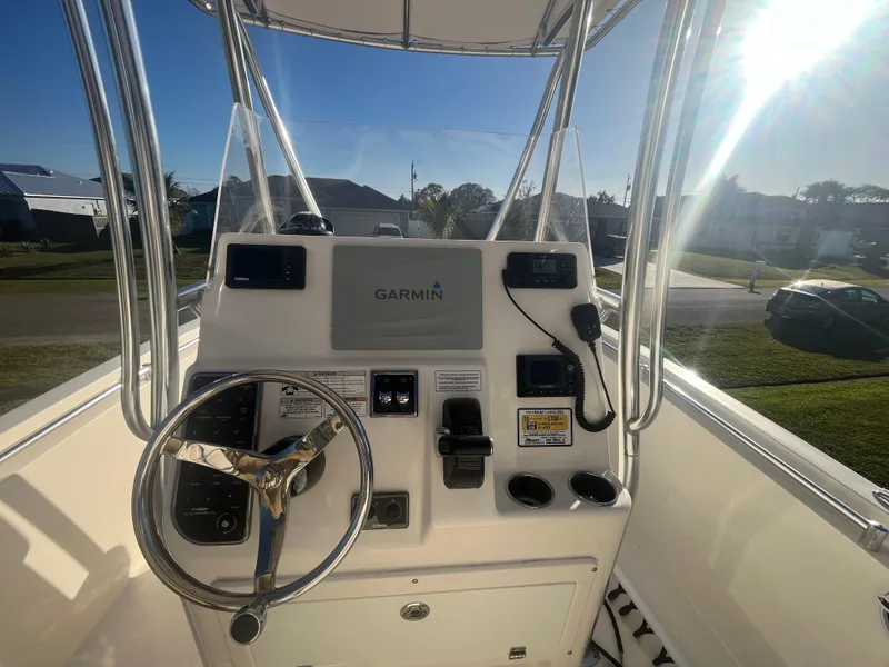 Slide: The Image of 2019 Cobia 237 Center Console boat helm with Garmin navigation system. - 25