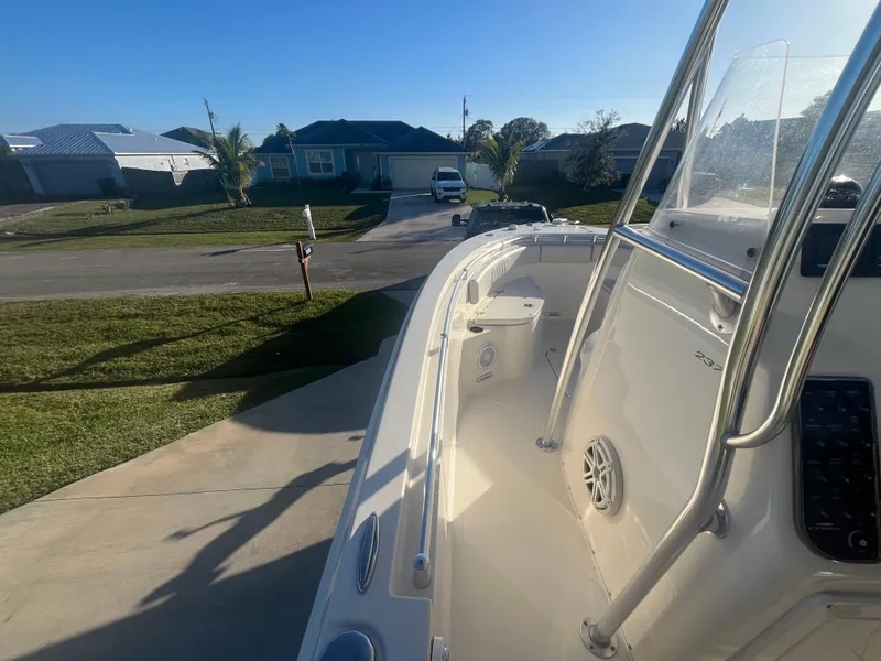 Slide: The Image of 2019 Cobia 237 Center Console boat parked in a residential driveway. - 28