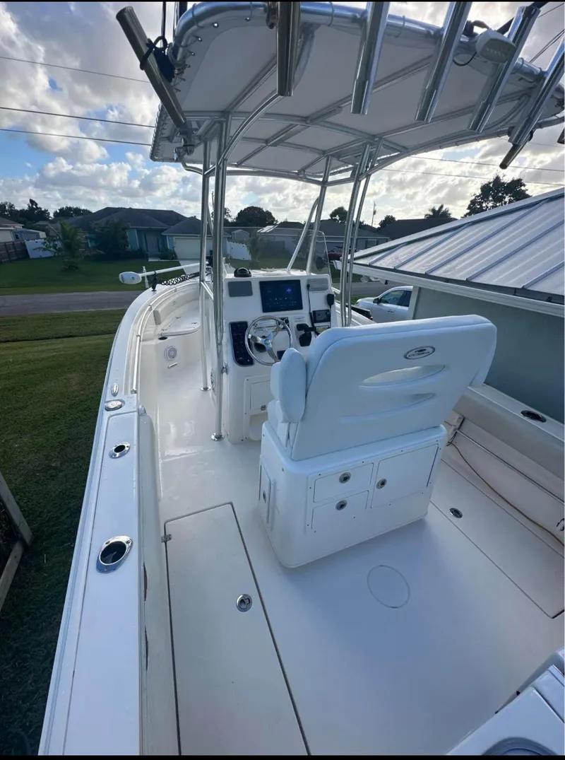 Slide: The Image of 2019 Cobia 237 Center Console boat with T-top and helm station. - 3