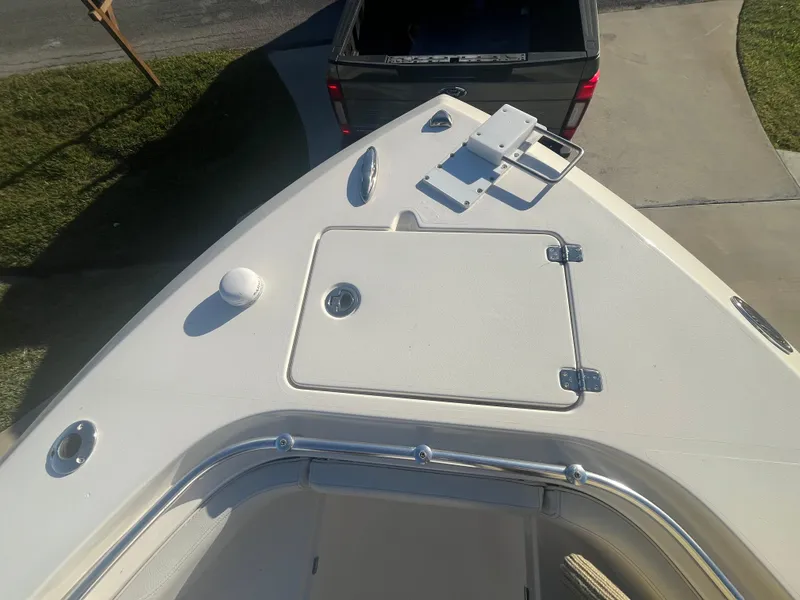 Slide: The Image of 2019 Cobia 237 Center Console boat bow view with storage hatch. - 31