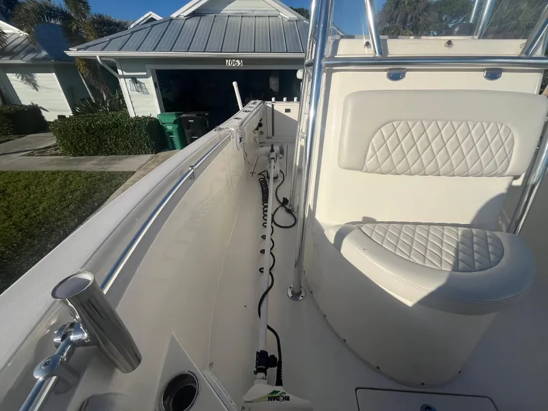 Slide: The Image of 2019 Cobia 237 Center Console boat with white seating and stainless steel railings. - 35