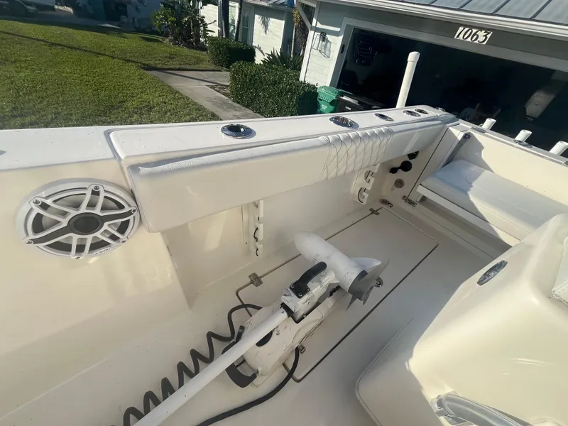 Slide: The Image of 2019 Cobia 237 Center Console boat interior with fishing rod holders and speaker. - 40