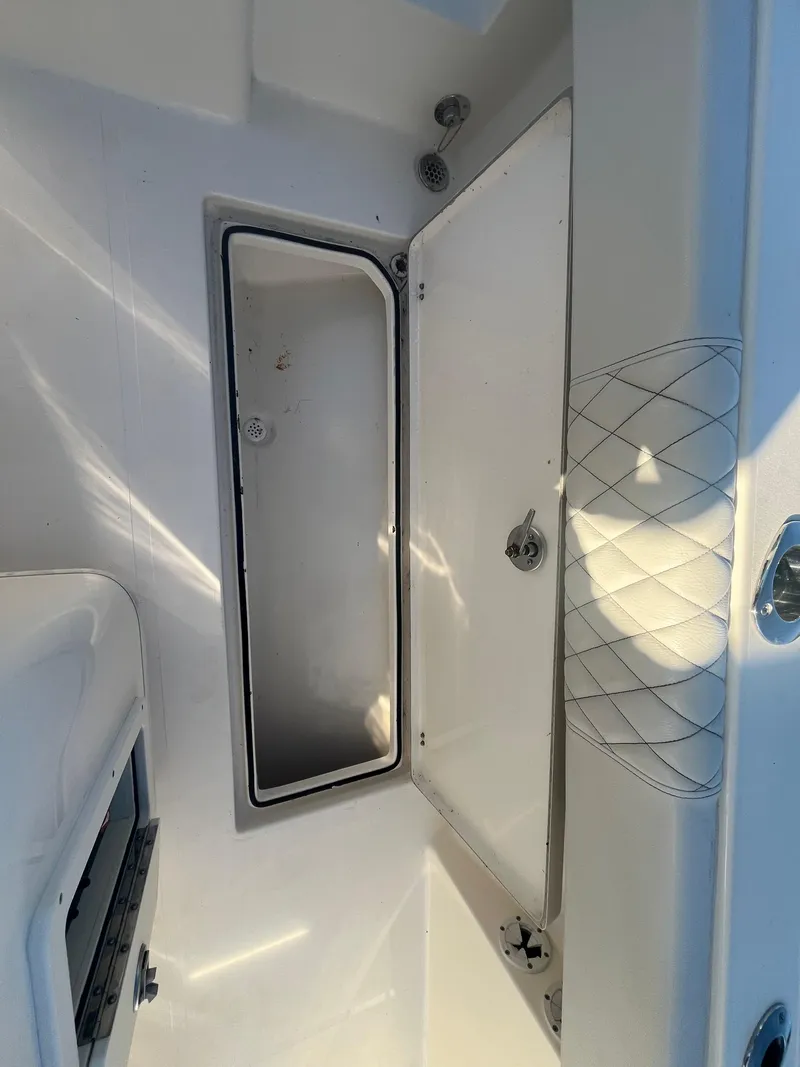 Slide: The Image of Open storage compartment on 2019 Cobia 237 Center Console boat. - 43