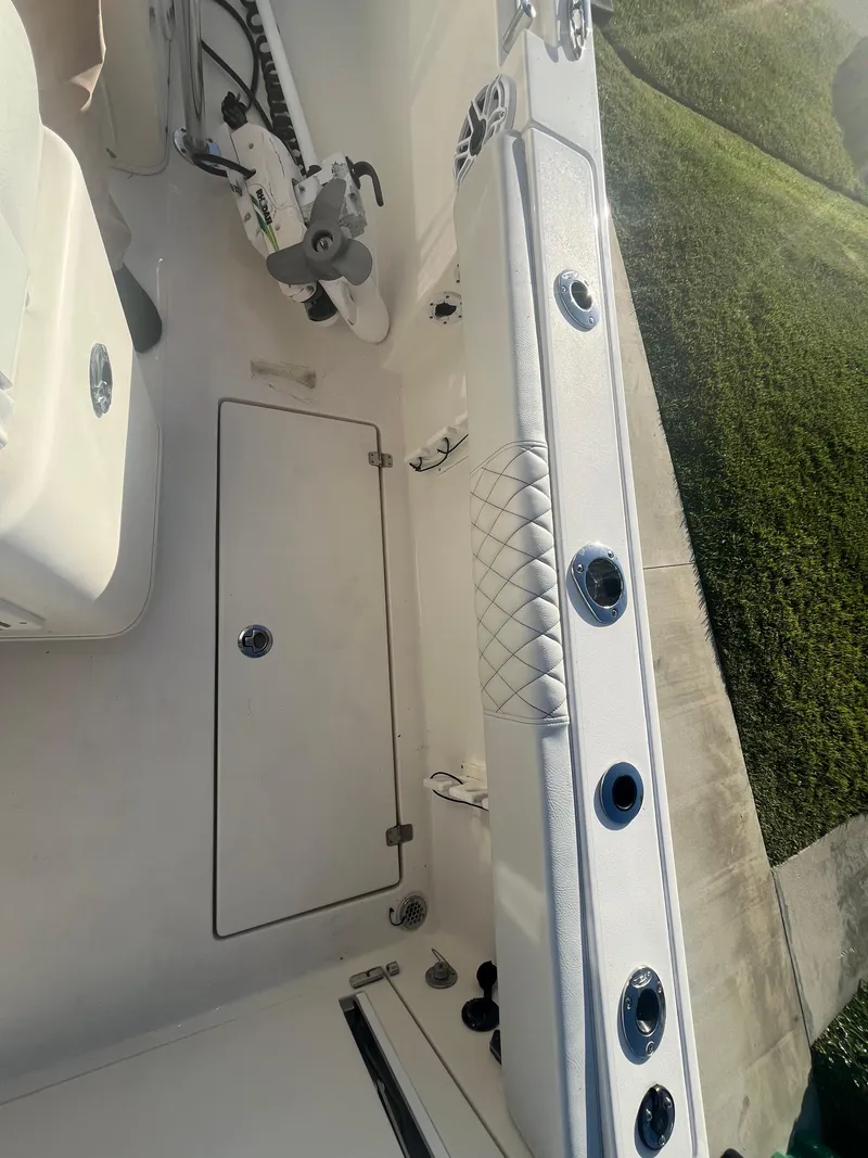 Slide: The Image of 2019 Cobia 237 Center Console boat interior with rod holders and storage. - 44