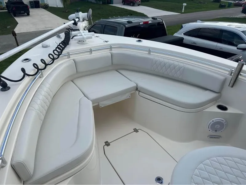 Slide: The Image of 2019 Cobia 237 Center Console boat with white cushioned seating area. - 5
