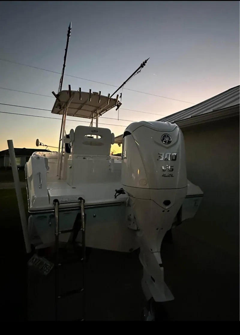 Slide: The Image of 2019 Cobia 237 Center Console boat with Yamaha engine at sunset. - 8