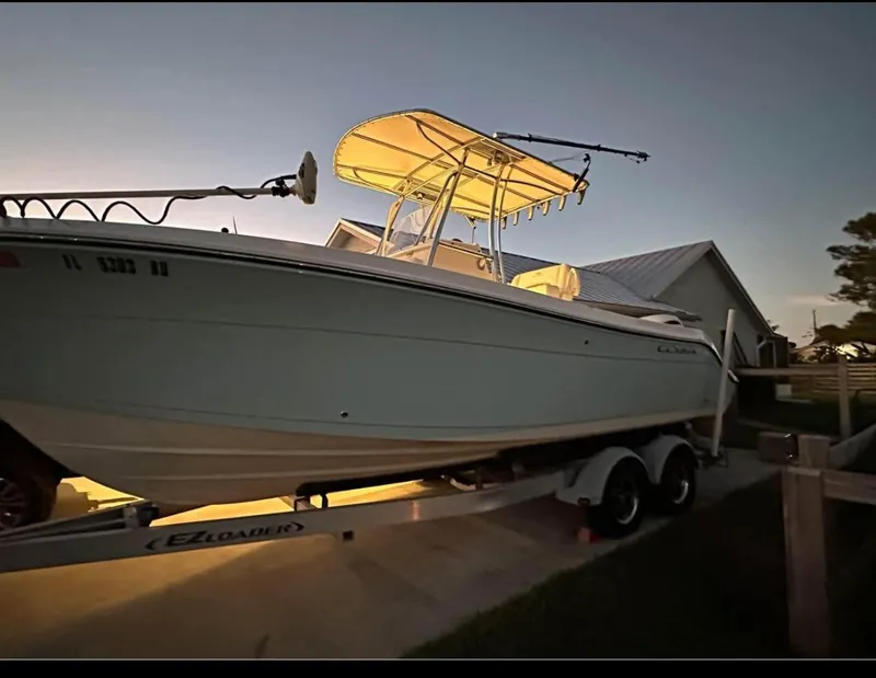 Slide: The Image of 2019 Cobia 237 Center Console boat on trailer at sunset. - 9