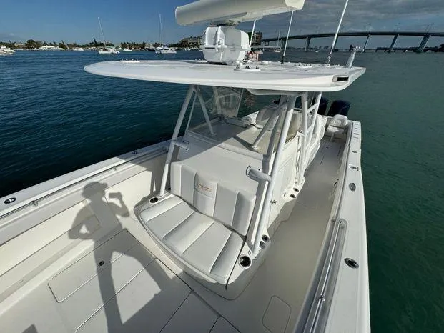 Slide: The Image of 2015 Invincible 39 Open Fisherman boat on calm water, featuring spacious deck and seating. - 18
